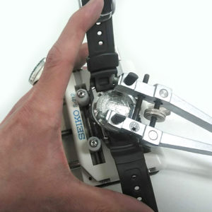 スクリュー式のG-SHOCK 腕時計電池交換の裏ブタをあける為、
MKS 明工舎製 メイコー 2爪式側開け器を使って丁寧に裏蓋を開けている様子
